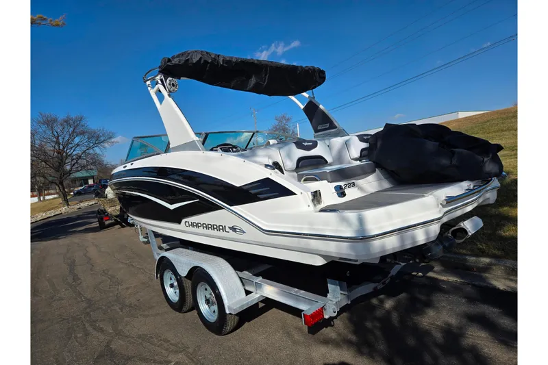 Slide: The Image of 2018 Chaparral Vortex 223 VR boat on trailer, parked outdoors under clear blue sky. - 3