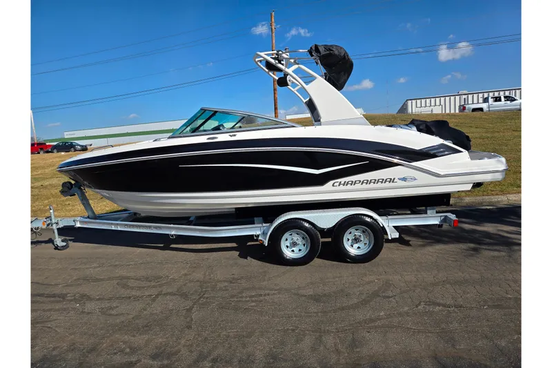 Slide: The Image of 2018 Chaparral Vortex 223 VR boat on trailer, parked outdoors under clear sky. - 4