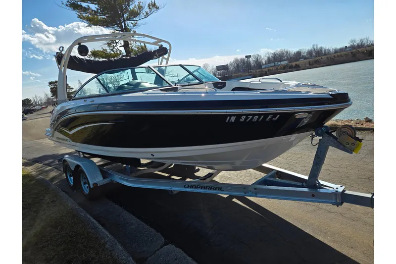 Slide: The Image of 2018 Chaparral Vortex 223 VR boat on trailer by a lake. - 8