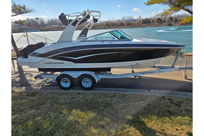Slide: The Image of 2018 Chaparral Vortex 223 VR boat on trailer by a lake. - 9