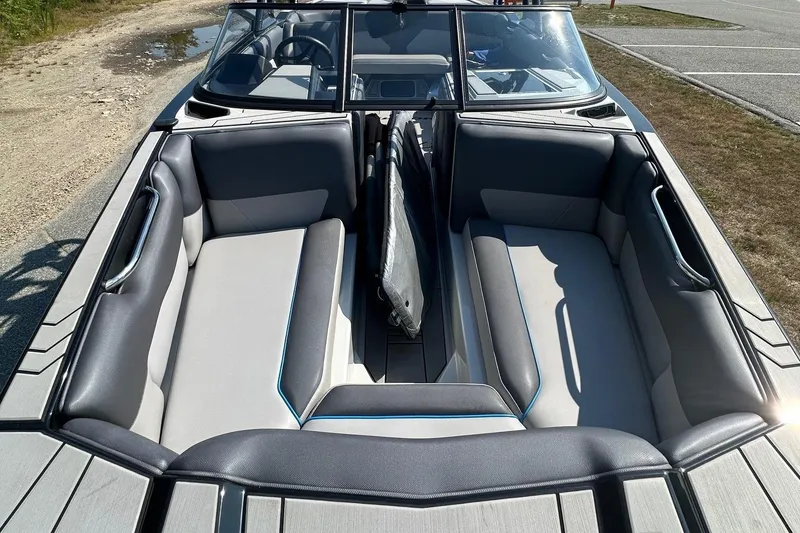 Slide: The Image of 2019 Moomba Helix boat interior with gray seating and open bow design. - 6