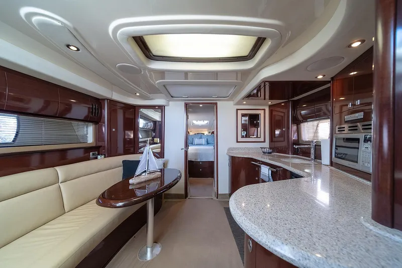 Slide: The Image of Luxurious interior of 2008 Sea Ray 440 Sundancer yacht with modern kitchen and seating area. - 13