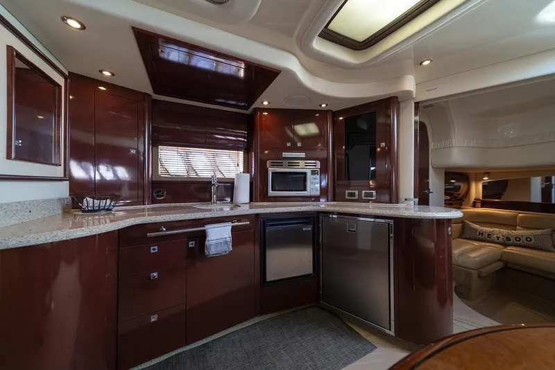 Slide: The Image of Luxurious 2008 Sea Ray 440 Sundancer yacht interior with modern kitchen and seating area. - 16