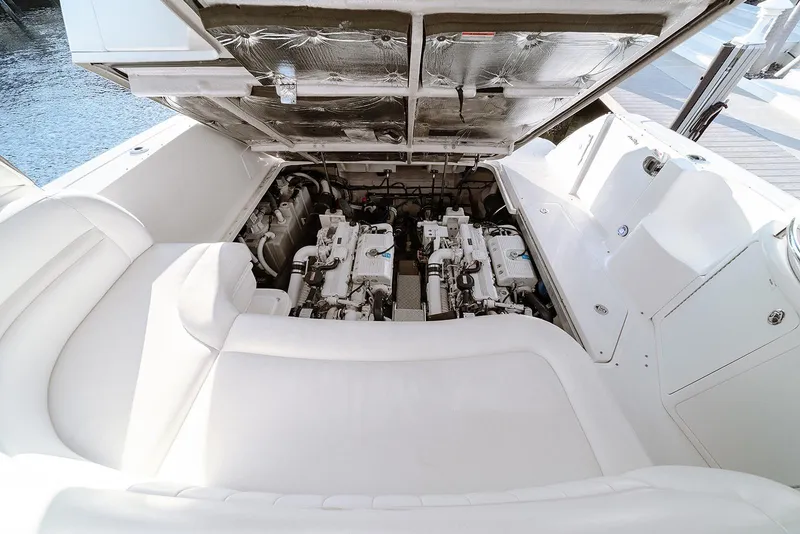 Slide: The Image of Engine compartment of 2008 Sea Ray 440 Sundancer yacht, showcasing dual engines and white seating. - 26