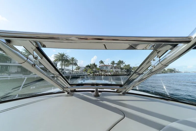 Slide: The Image of View from 2008 Sea Ray 440 Sundancer yacht, showcasing waterfront homes and palm trees. - 11