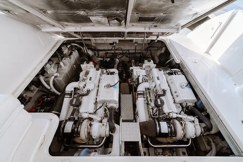 Slide: The Image of Engine compartment of a 2008 Sea Ray 440 Sundancer, showcasing dual engines and mechanical components. - 23