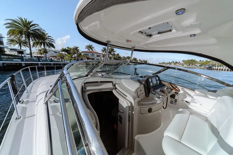 Slide: The Image of 2008 Sea Ray 440 Sundancer yacht cockpit with luxurious seating and navigation controls. - 8