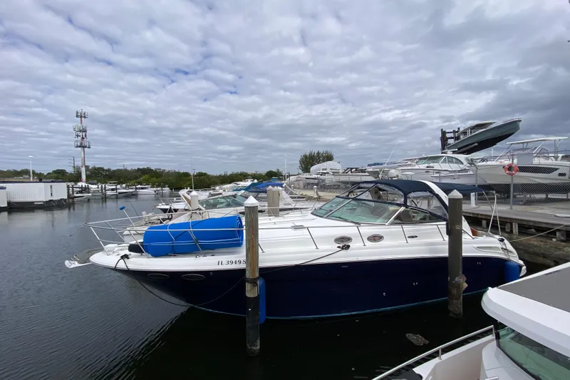 Slide: The Image of 2004 Sea Ray 380 Sundancer docked at marina under cloudy sky. - 0