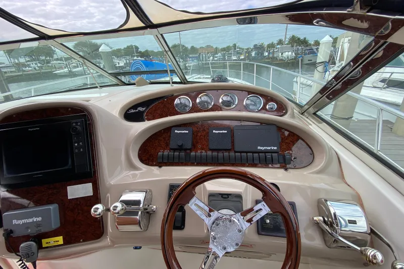 Slide: The Image of 2004 Sea Ray 380 Sundancer helm with Raymarine navigation, docked at marina. - 10