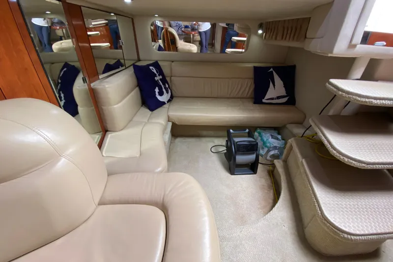 Slide: The Image of Interior of 2004 Sea Ray 380 Sundancer yacht with beige seating and nautical decor. - 16
