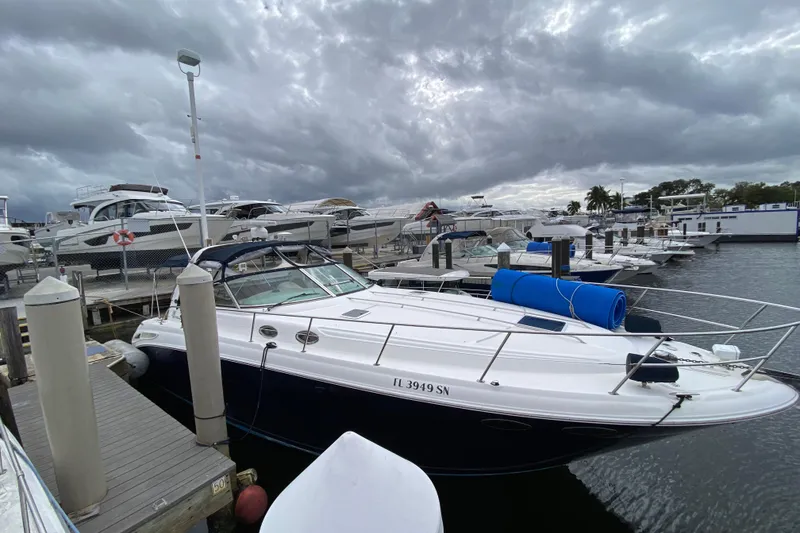 Slide: The Image of 2004 Sea Ray 380 Sundancer docked at marina under cloudy skies. - 2