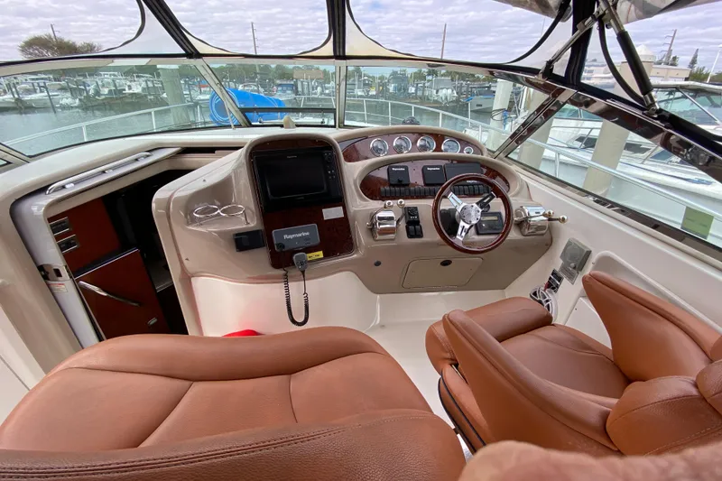 Slide: The Image of 2004 Sea Ray 380 Sundancer helm with leather seats and modern navigation equipment. - 6