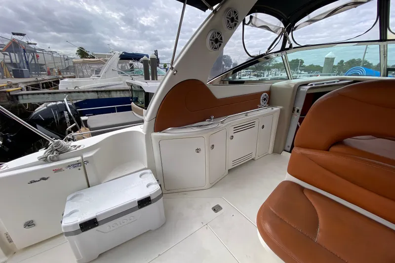 Slide: The Image of 2004 Sea Ray 380 Sundancer boat interior with brown seating and white cabinetry. - 9