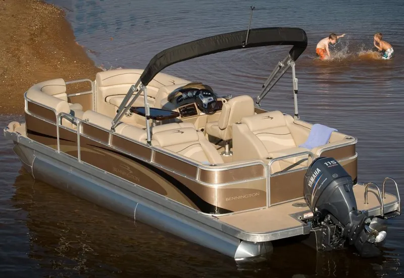 The Image of 2013 Bennington 2275 GCW pontoon boat on trailer, parked outside dealership. - 0