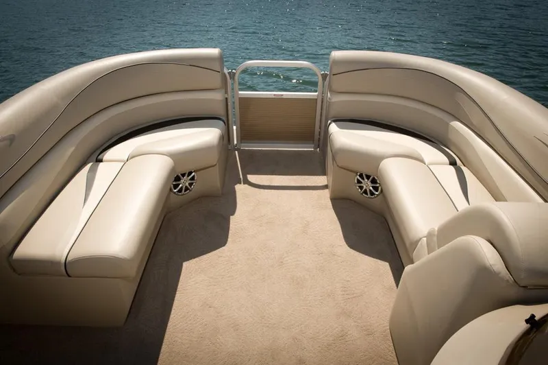 Slide: The Image of Manufacturer Provided Image: 2013 Bennington 2275 GCW boat interior with beige seating and lake view. - 1