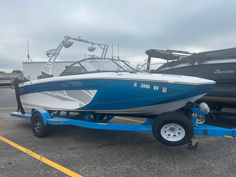 The Image of 2016 Tigé R20 boat on blue trailer parked outdoors. - 0