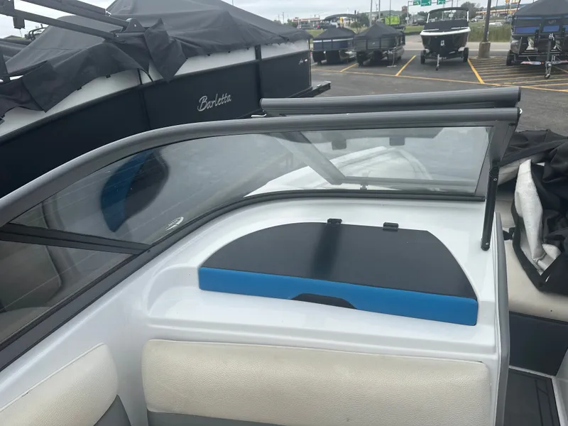 Slide: The Image of 2016 Tigé R20 boat cockpit with windshield and seating area. - 12