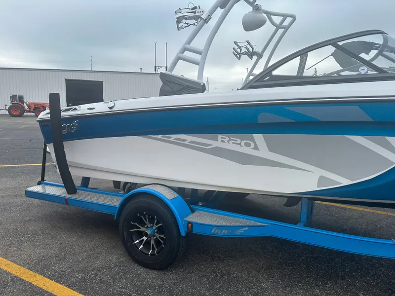Slide: The Image of 2016 Tigé R20 boat on trailer, blue and white design. - 2