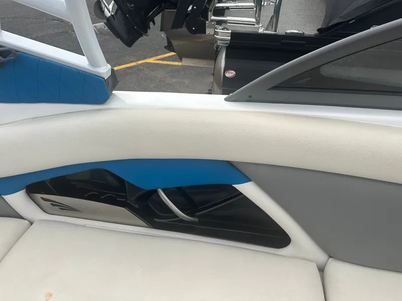 Slide: The Image of Interior of a 2016 Tigé R20 boat with blue and white upholstery. - 21