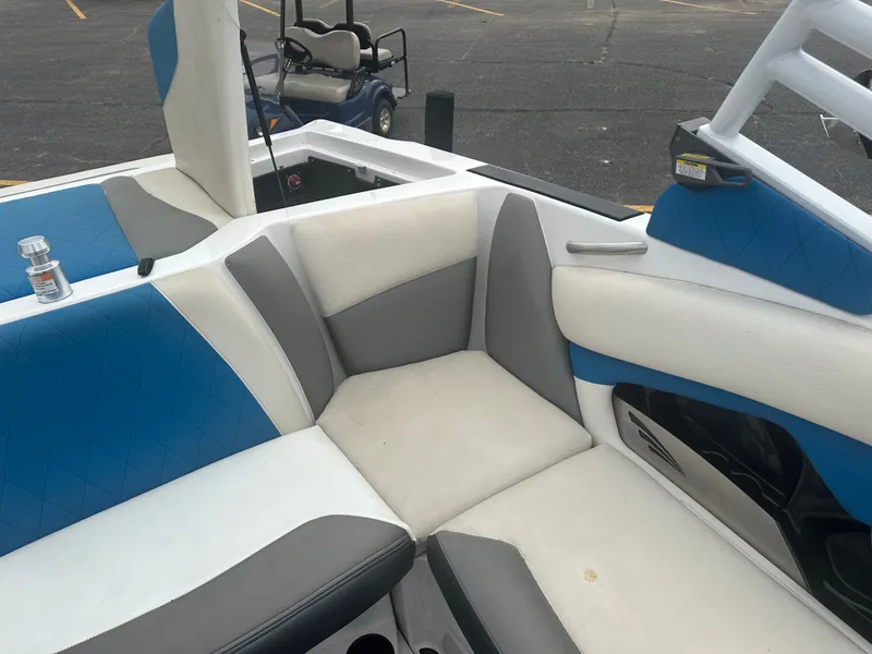 Slide: The Image of Interior of a 2016 Tigé R20 boat with blue and gray seating. - 22