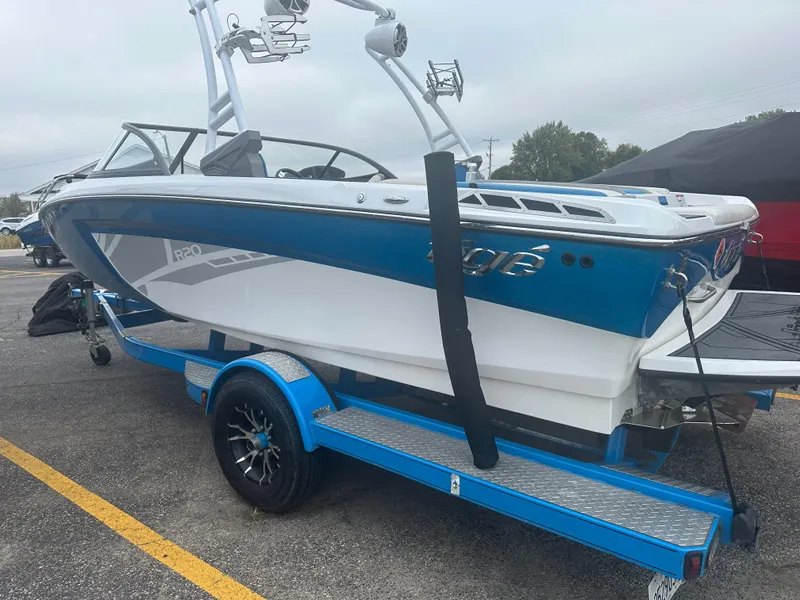 Slide: The Image of 2016 Tigé R20 boat on blue trailer parked outdoors. - 3