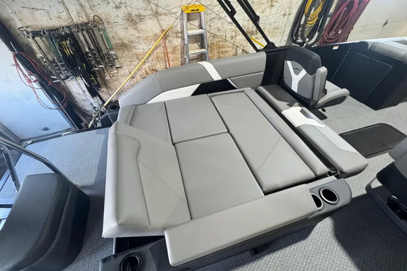Slide: The Image of 2026 Evotti 521CS boat interior with gray seating and cup holders in a workshop setting. - 10