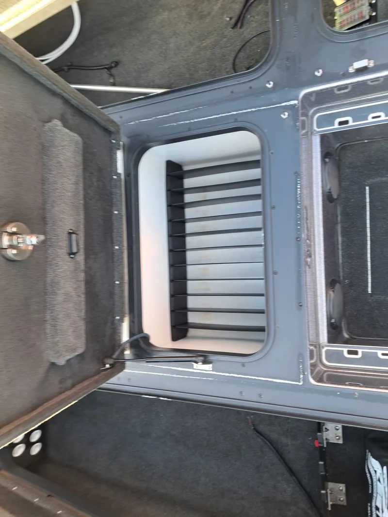 Slide: The Image of Open storage compartment in 2014 Skeeter FX21 boat. - 15