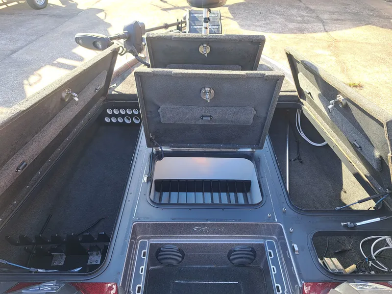Slide: The Image of 2014 Skeeter FX21 boat with open storage compartments. - 16