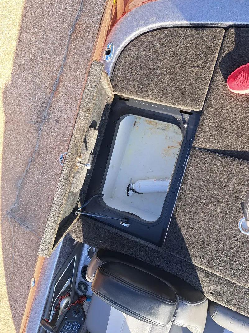 Slide: The Image of Open storage compartment of a 2014 Skeeter FX21 boat. - 23