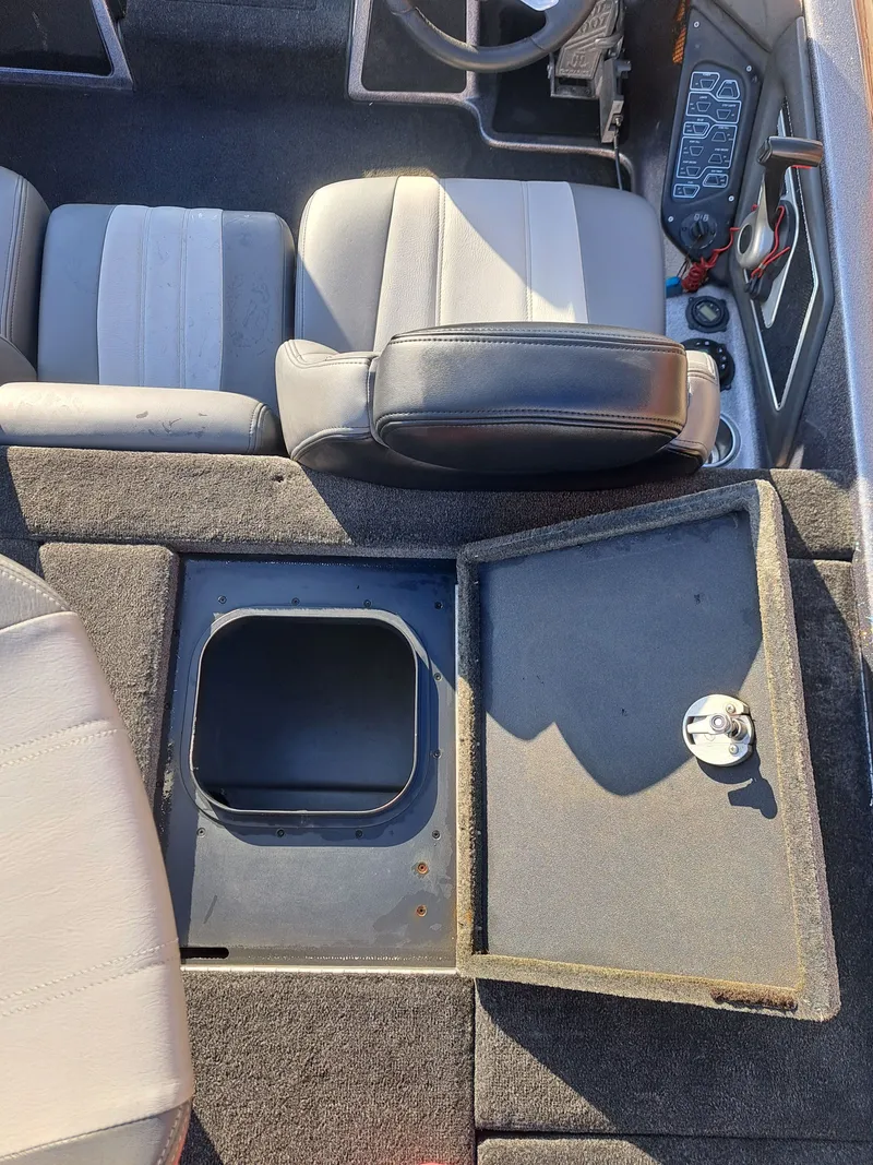 Slide: The Image of Interior of a 2014 Skeeter FX21 boat with open storage compartment. - 24