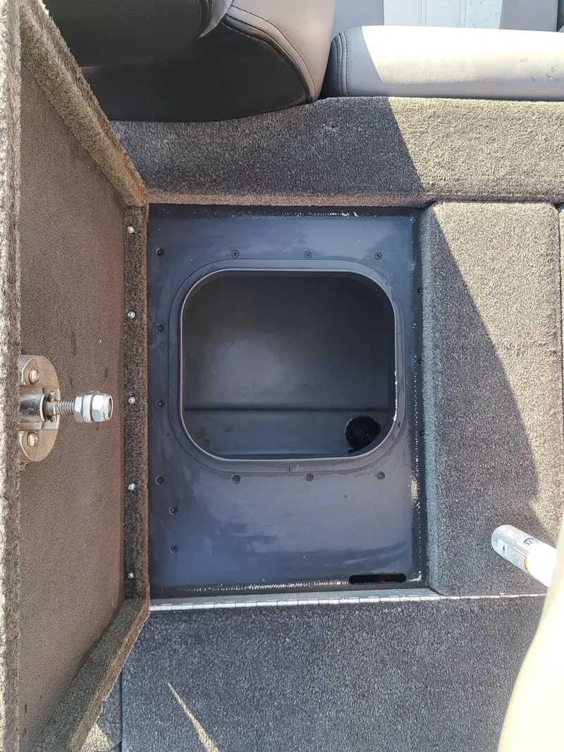 Slide: The Image of Open storage compartment of a 2014 Skeeter FX21 boat. - 26