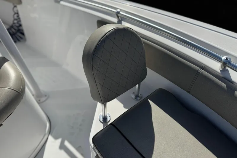Slide: The Image of 2022 Sportsman Open 212 Center Console boat seating detail with cushioned backrest. - 16