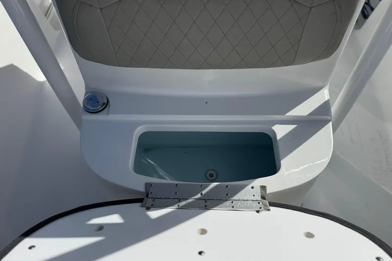 Slide: The Image of 2022 Sportsman Open 212 Center Console boat seat and storage compartment. - 19