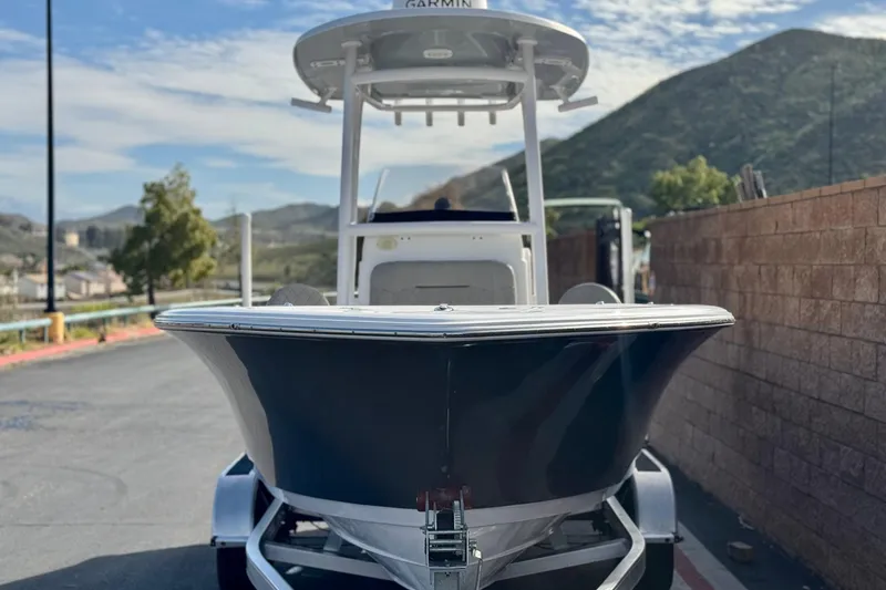 Slide: The Image of 2022 Sportsman Open 212 Center Console boat on trailer, scenic mountain backdrop. - 2