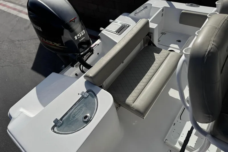 Slide: The Image of 2022 Sportsman Open 212 Center Console boat with Yamaha 150 engine, featuring cushioned seating. - 22