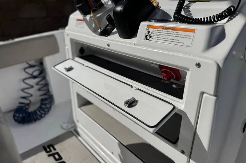 Slide: The Image of 2022 Sportsman Open 212 Center Console boat dashboard with open storage compartment. - 35