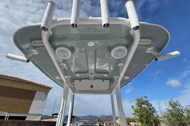 Slide: The Image of 2022 Sportsman Open 212 Center Console boat with T-top and rod holders under blue sky. - 39