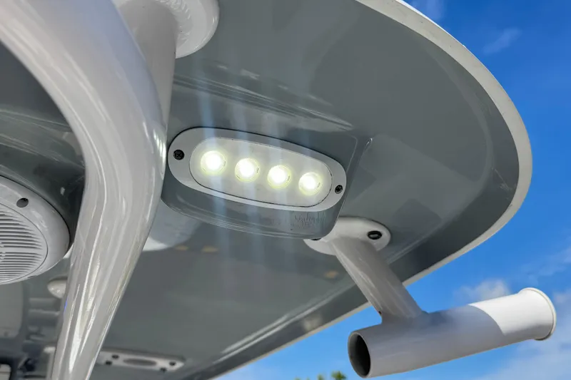 Slide: The Image of LED lights on 2022 Sportsman Open 212 Center Console boat against blue sky. - 41