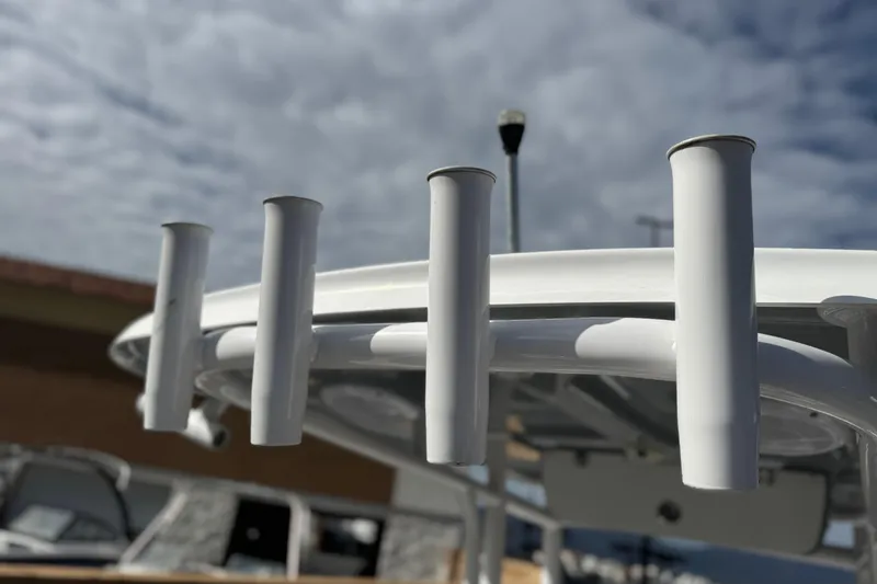 Slide: The Image of Rod holders on a 2022 Sportsman Open 212 Center Console boat under a cloudy sky. - 42