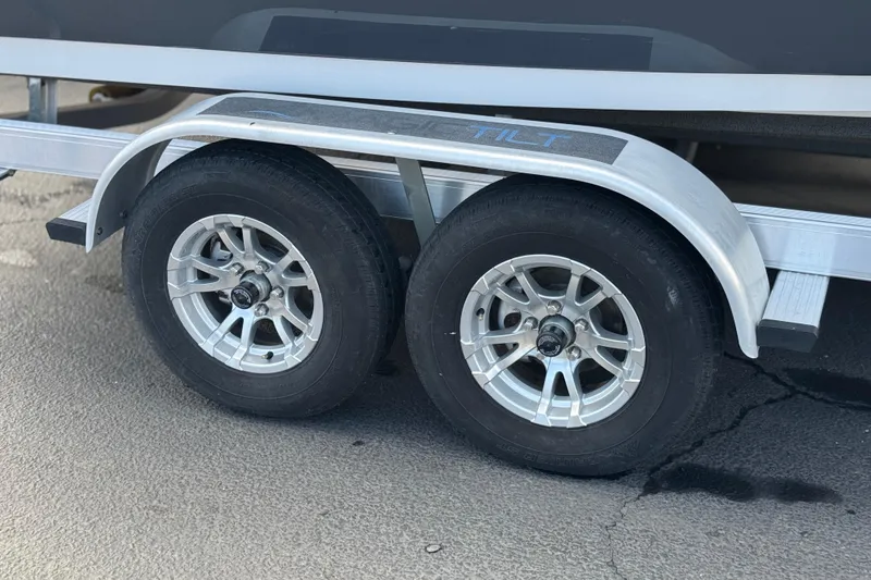 Slide: The Image of Trailer wheels of a 2022 Sportsman Open 212 Center Console boat. - 48
