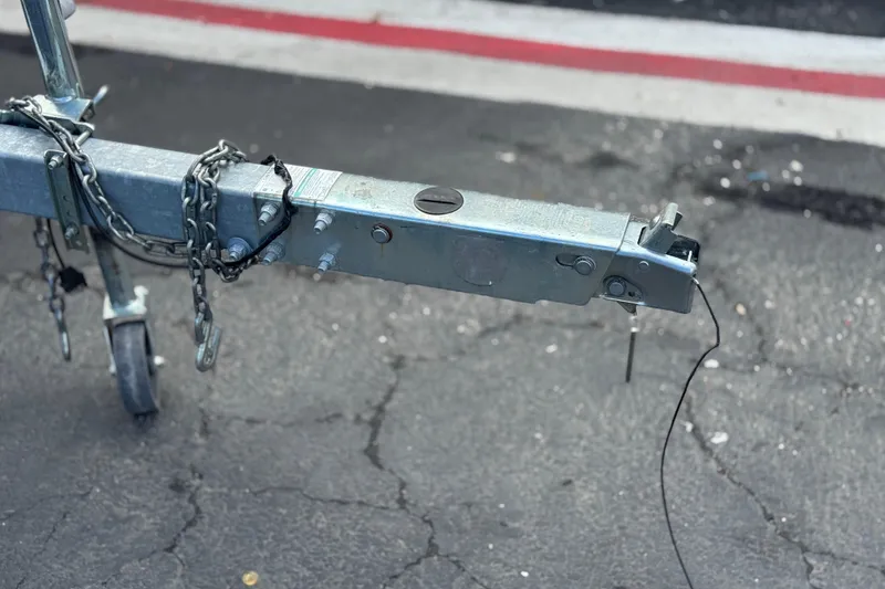 Slide: The Image of Trailer hitch of a 2022 Sportsman Open 212 Center Console on asphalt. - 49