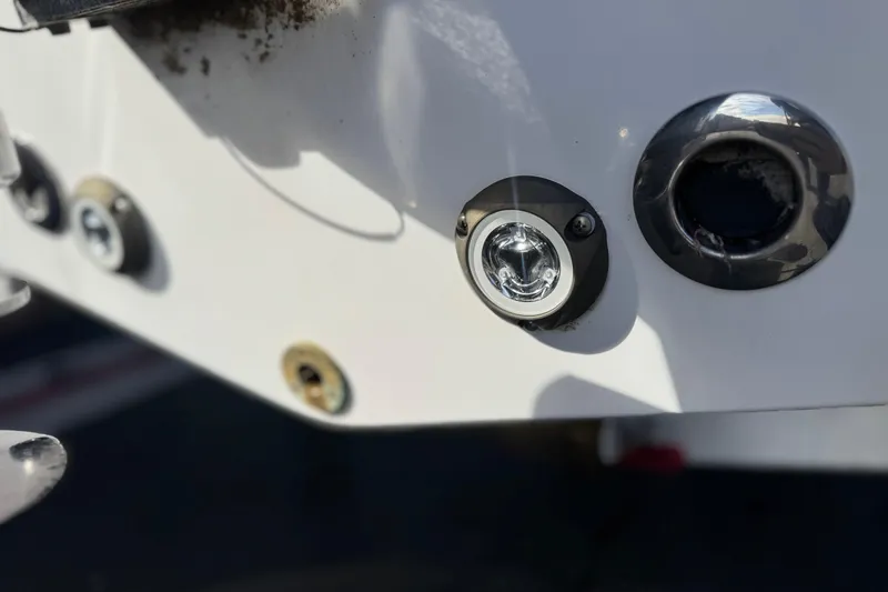 Slide: The Image of 2022 Sportsman Open 212 Center Console boat detail with metal fixtures and light. - 9