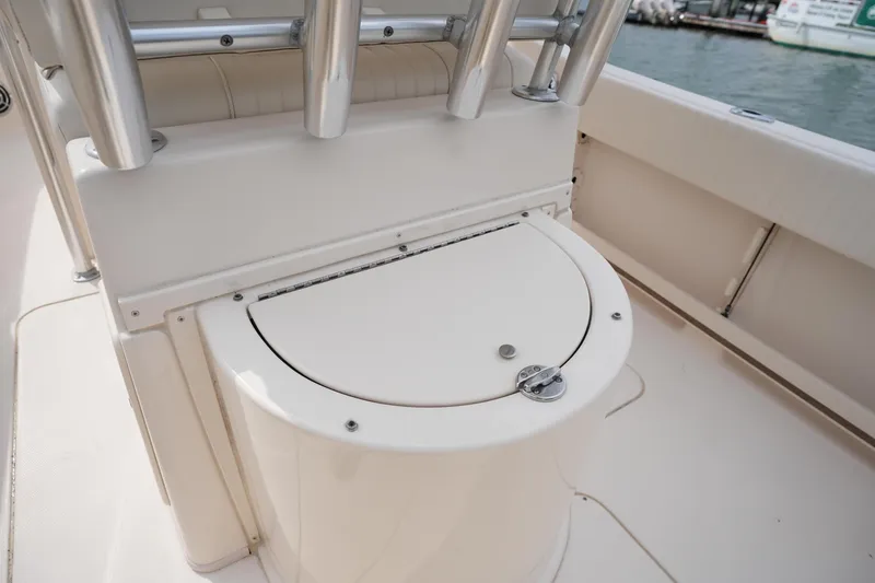 Slide: The Image of 2014 Grady-White Fisherman 209 boat interior with storage compartment and rod holders. - 14