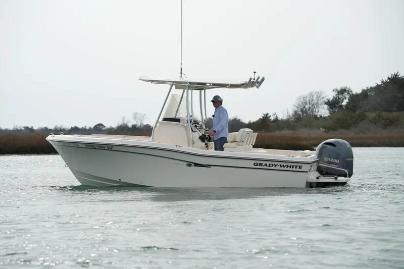 Slide: The Image of 2014 Grady-White Fisherman 209 boat on calm water with Yamaha engine. - 2