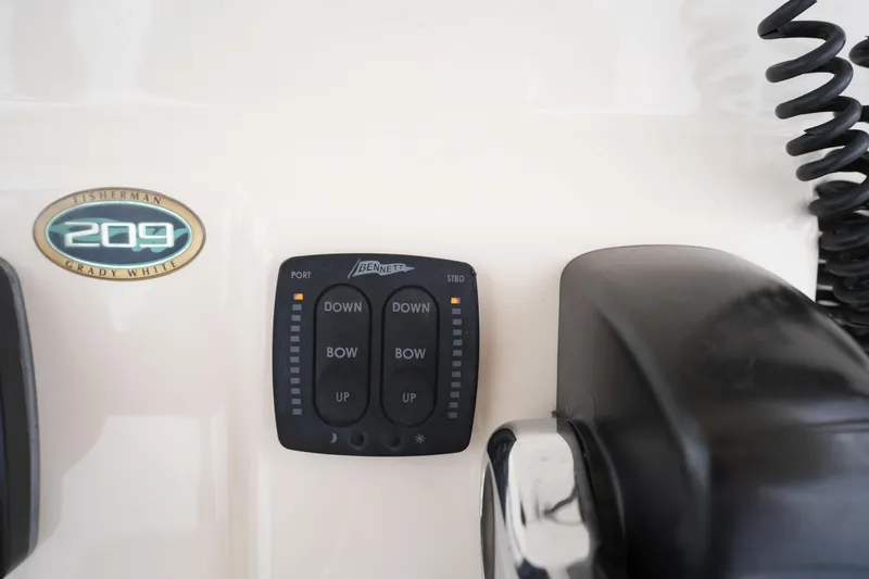 Slide: The Image of Control panel of 2014 Grady-White Fisherman 209 boat with trim tab switches. - 27