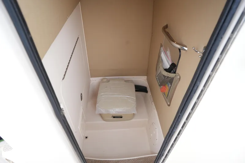 Slide: The Image of 2014 Grady-White Fisherman 209 boat interior storage compartment with portable toilet. - 29