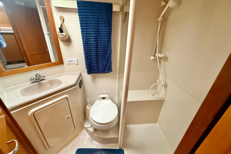 Slide: The Image of 1998 Riviera 34 Convertible bathroom with shower, sink, and toilet. - 24
