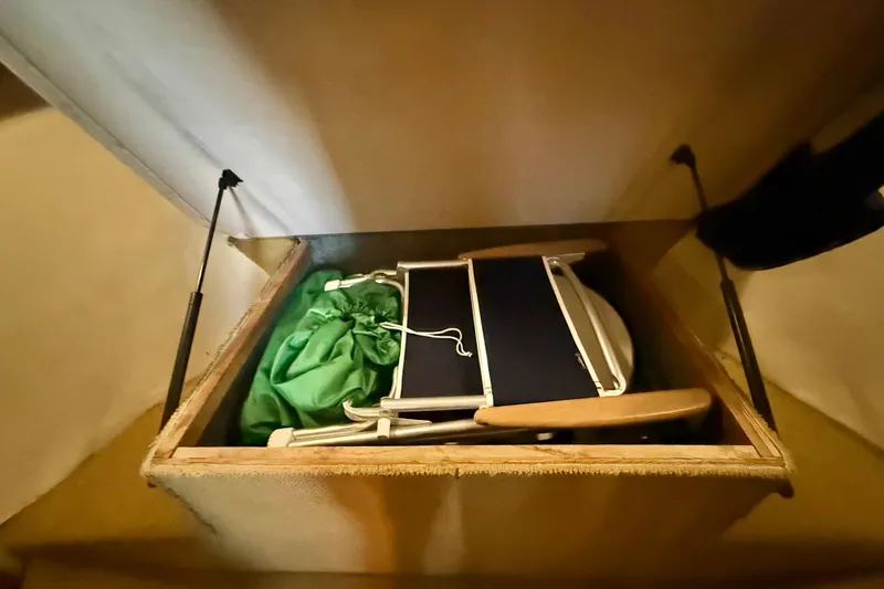 Slide: The Image of Storage compartment in 1998 Riviera 34 Convertible with green bag and folding chair. - 29