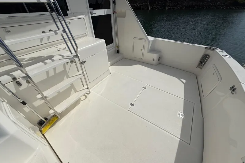 Slide: The Image of Spacious deck of 1998 Riviera 34 Convertible yacht with ladder and storage compartments. - 32