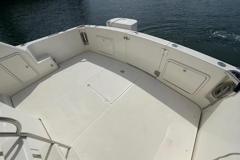 Slide: The Image of Spacious deck of 1998 Riviera 34 Convertible boat with storage compartments. - 33